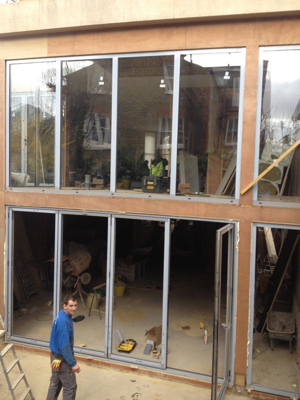Aluminium bi-fold doors with two-storey glazing in Iver