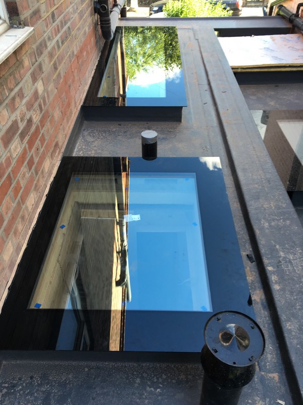 Multiple flat roof skylights on extension in Iver